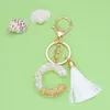 Keychains Style White Tassel Letter Keychain Gold Foil Crystal Glue Fashion 26 English Pendant Charms Small Gift For Couple Emel22