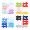 10st / Lot Mini Bow Tie Hair Clip Liten Söt Solid Ribbow Bow Säkerhet Ribbon Täckt Klämma för Kids Hairpins Tillbehör Gåvor AA220323