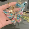 Söt nyckelring färgglad fjäril nyckelring emaljdjur nyckelkedjor bil kristalltangentare kvinnor flickor handväska tillbehör