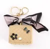 Porte-monnaie en cuir porte-clés porte-clés foulard en soie porte-écouteurs porte-clés de voiture PU mini portefeuille fleur sac breloques pendentif bijoux accessoires pour femme cadeau