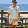 Casablanca 22SS White laranja cacto de tênis impressão casual casual masculino e feminino Camisa de manga curta Botão de verão