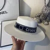 Small fragrance letter Ribbon Pearl flat top straw hat European and American fashion light luxury wind wide brimmed hat retro women's sun visor