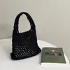 Qualité classique fait à la main portable tissé évidé sac à main mode tout match sac en maille avec doublure vide petit sac de plage