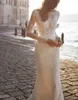 Abito da sposa a sirena in pizzo bohémien unico con strascico staccabile Abiti da sposa trasparenti con scollo a V e maniche lunghe con apertura sul retro