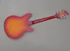 Vänster körsbärs solbrastelektriska gitarr med palisanderbrädan