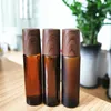 Amber Glass Roll-on flessen houtkorrel plastic dop matte etherische olie parfum fles met roestvrijstalen rollerbal 5 ml 10 ml 15 ml
