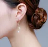 Boucles d'oreilles en or de longues doubles à double perle