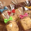 Cadeau cadeau 100pcs coloré soie noeud noeud fil d'étanchéité West Point Lollipop Biscuit sac emballage cravate bonbons chocolat accessoires cadeau