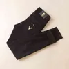 冬の秋のジーンズメンズファッション韓国版スリムフィットスモールフィート弾性汎用ブラックカジュアルパンツ