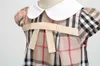 Toddler Designer Girls Robes Vêtements Classic Grid Coumter Couleur Revers Preppy Style Bow Kids Robe Summer Sumwear Suit Party T8452500