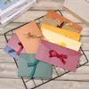 Confezione regalo 10 pezzi / set Busta di carta retro perlescente Fiocco spesso nastro Sacchetti di biglietti di auguri di colore creativo per cartoline di invito a nozzeRegalo