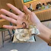 Llaveros de cuero Anillos Joyería Flor marrón A cuadros Borla Monedero Llaveros Colgante Moda Mini bolsa de almacenamiento Charm Llaveros Accesorios