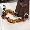 Designers iPhone case chocolate tortoise shell carrying chain 13pro max / 12 13 11 mobile phone cases full package X xsmax men and women good