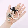 2022 Imitation Pearl Perfym Bottle Keychain Car Key Ring Holder Bag Charm Pendant Accessories Bow Key Chain Fashion Keyring AA2203181751