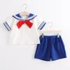 Kläder sätter högkvalitativa modeflickor/pojkar professionella skolblått och vita korta ärmar uniformer kostym trikel flickkläder