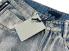 Jeans masculinos para homens e mulheres Blue Designer Version France Paris Zipper de alta qualidade Calças de hip-hop Padrão de letra de algodão