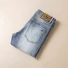 Våren 2022 och sommaren tunn ljus färg koreanska jeans för män elastiska hål tvättade smala långa byxor