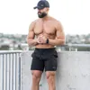 Mężczyźni siłowni fitness luźne szorty kulturystyka joggery lato szybkie chłodne krótkie spodnie męskie dres na plażę 220611