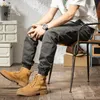 Calças masculinas de estilo coreano Men jeans Jeans Spliced ​​Designer Cargo casual macacão de rua de rua Hip Hop Harém HAREMERS HOLEMEN NAOM