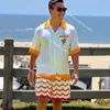 Casablanca 22SS White laranja cacto de tênis impressão casual casual masculino e feminino Camisa de manga curta Botão de verão