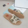 Klapki od projektantów Woody Mules Pantofle Płócienne krzyżowo tkane sandały Klasyczne damskie sandały Lato Outdoor Peep Toe Dorywczo pantofel List Stylist Shoes