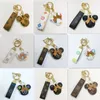 Mode clé boucle voiture porte-clés à la main en cuir porte-clés hommes femmes sac pendentif accessoires souris conception fleur charme bijoux porte-clés pour filles cadeaux