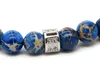 New Design High Grade Jewelry Wholesale 8mm Blue Sea Sediment Stone Bead with Bronze Gold and Silver Skull Bracelet