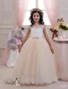 2016 Blush Abiti da sposa in miniatura con collo trasparente e lunghezza del pavimento in rilievo Tulle Light Champagne Flower Girls Abiti su misura