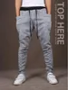 Großhandels- einzigartiger Entwurfs-Harem-Hosen-Männer elastische Taillen-Sport-Hosen-koreanische kühle dünne passende Jogginghose-Tropfen-Gabelungs-Hosen-Männer schwarz