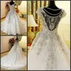 Luxury Crystal Beaded Bröllopsklänningar Romantiskt En Linje Cap Sleeve Tulle Lace Applique Långa Kvinnor Bröllop Party Gowns