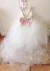 2016 bloem meisjes jurken voor bruiloften kralen spaghetti geplooide tule schattige roze boog eerste communie jurken pageant jurken voor meisjes