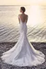 Strand Lace Mermaid Bröllopsklänning 2019 Sexig passform och flare Se igenom Tillbaka Appliques Tulle Bridal Gowns med Sheer Shoulder Cap Sleeve Button