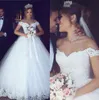 2020 New Modest Cheap Arabic Ball Gown Wedding Dresses Plus Size Lace Applique Off Shoulder Puffy Tulle Sweep Train Formal Bridal Gowns