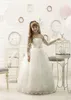 見事な長袖の花の女の子のドレス結婚式用のアップリケレースチュールフロアレングスファースト聖体拝領