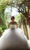 Luxury Crystals Beaded Ball Gown Wedding Dresses 2017 Modest Sheer Neck Illusion Long Sleeves Tulle Puffy Lace Up Backless Bridal Gowns