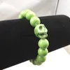 Chinesische Art-Grün-Schädel-Charme-Armbänder 10mm keramische wulstige dehnbare Armbänder für Halloween-Partei 12pcs Großverkauf