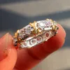 ブランドジュレリー女性925シミュレートダイヤモンドキュービックジルコニアタンザナイトイエローゴールドクロス永遠のバンド結婚指輪