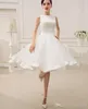 Vestido de novia de organza hasta la rodilla de raso sin espalda recortado con fajín de decoración de lazo