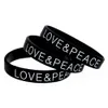 Bracciale in gomma siliconica Love and Peace da 100 pezzi con logo stampato nero per regalo di promozione di attività di fondazione di beneficenza