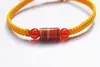 Le bracelet porte-bonheur noeud plat jaune + perles cylindriques de sardonyx