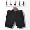 Partihandel- varumärke sommar svarta vita män jeans shorts bomull rippade denim korta byxor kvalitet solid Slim modestil Bermuda hane