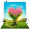 Décors d'arbres en forme de coeur avec des fleurs roses soleil bleu ciel vert prairie beau paysage de printemps fond de mariage romantique en plein air