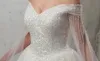 Funkelnde Ballkleid-Hochzeitskleider mit großen Perlenstickereien, Pailletten, Schleppe, elfenbeinfarbene Brautkleider mit abnehmbarem Überwurf