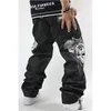 Pantalones vaqueros negros de moda para hombre, pantalones vaqueros de mezclilla con bordado de calaveras, pantalones rectos sueltos holgados de Hip Hop, pantalones de patineta Harem de talla grande 30-44