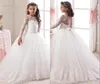 Ilusión Mangas largas Vestidos para niñas de flores 2019 Nuevo encaje Apliques Arco Sash Vestido de fiesta Tren de barrido Niños Ropa formal Vestidos para niñas