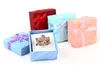 48 pièces/pièces boîte cadeau bijoux boîte à bagues arc pour taille de bague 4 cm * 4 cm * 3 cm 4 couleurs rouge bleu rose violet sélection