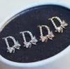 D-Letter Brand Stud-oorbellen Geplaatste 18K gouden micro-set zirkoon boog knoop high-end oorbellen Koreaanse mode zoete vrouwen voortreffelijke oorbellen sieraden Valentijnsdag cadeau spc