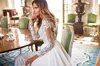 2018 Bohemian A Line Abiti da sposa Summer Beach Sheer Neck maniche lunghe Illusion Side Split Appliques in pizzo Chiffon Foraml Abiti da sposa