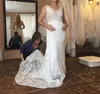 2018 Abiti da sposa a sirena da spiaggia sexy Tessuto in pizzo con scollo a V Illusion Corpetto Corte dei treni Abiti da sposa aderenti con tasche