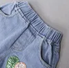 Tute per bambini Neonate Abbigliamento per bambini Set T-shirt stampata Pantaloncini di jeans con foro + Fascia per capelli Set di abbigliamento 2023 Completi estivi Set 3 pezzi